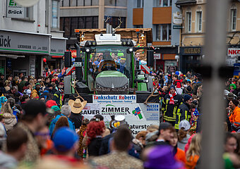 Karnevalszug in Adenau mit festlich geschmücktem Traktor und bunt kostümierten Besuchern, Verbandsgemeinde Sonntags Zug.